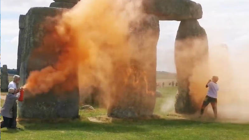 Just Stop Oil protesters spraying an orange substance on Stonehenge