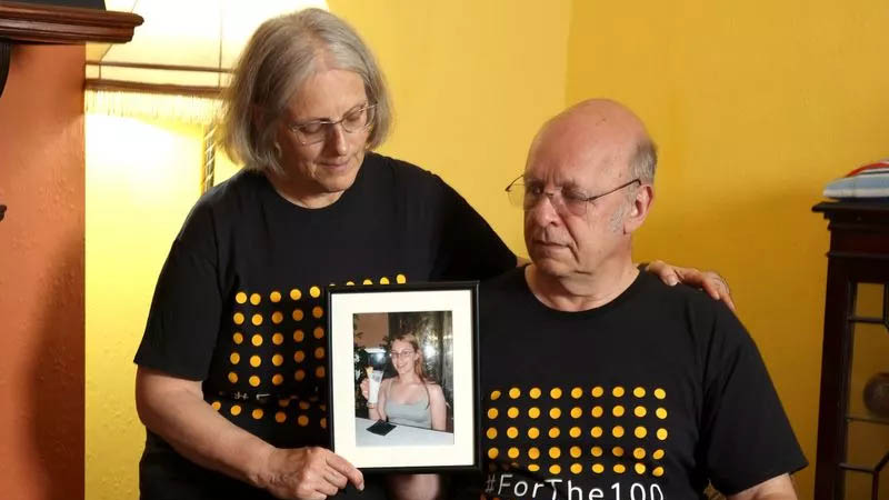 Bob and Maggie with picture of their Daughter